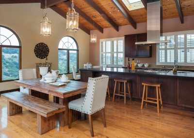 rustic kitchen and dining room with high beam ceilings